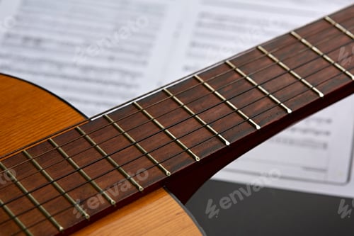 Preview: Acoustic guitar, music book on background, nobody
