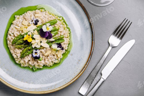Preview: Gourmet risotto with edible flowers on elegant table setting