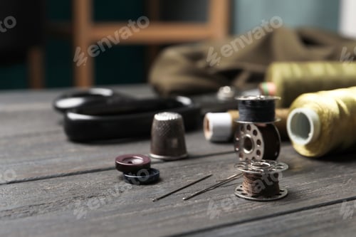 Preview: Bobbins with threads on table. Tailoring accessories