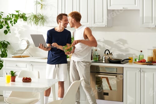 Preview: A joyful couple cooking a fresh salad together in their modern kitchen