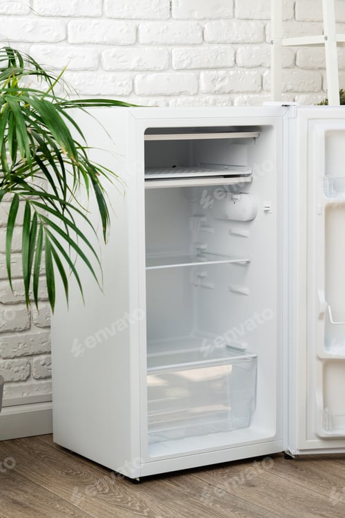 Preview: White Refrigerator Open Against Brick Wall