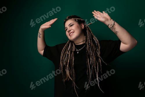 Preview: Woman With Dreadlocks Standing in Front of Green Background