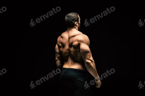 Preview: back view of shirtless sportive man showing muscles isolated on black