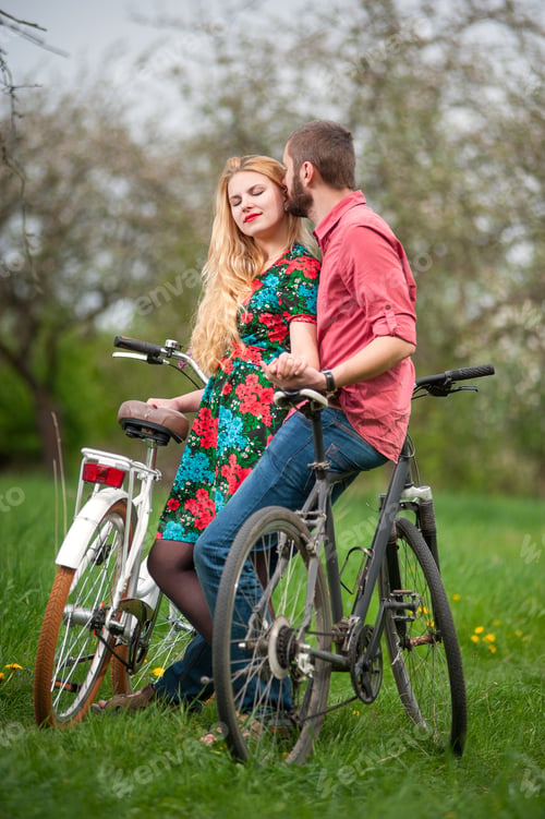 Preview: Loving young couple with bicycles