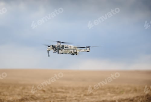 Preview: Portable quadcopter against a blue sky with white Cirrus clouds.