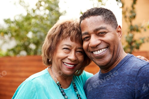 Preview: Senior black woman and her middle aged son smiling to camera, head and shoulders, close up