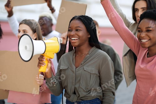 Preview: Cheerful black lady leading international group of protestors