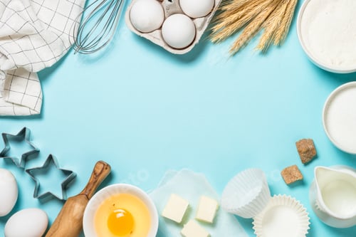 Preview: Baking ingredients at blue table top view