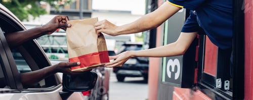 Preview: Hand Man in car receiving coffee in drive thru fast food restaurant.