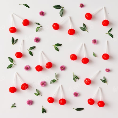 Preview: Colorful pattern made of red cherry lollipops, leaves, and flowers.
