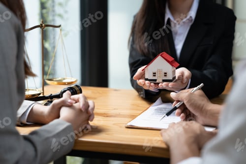 Preview: happy couple husband wife signing rental contract at meeting with realtor or landlord, first
