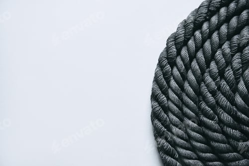 Preview: Close up of black battle rope on a gray backgound. Sport and fitness equipment