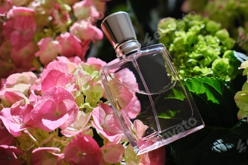 Preview: delicate pink perfume bottle on flower background.