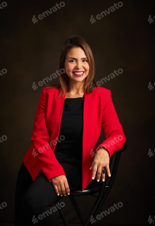 Preview: Confident Woman in Red Blazer Poses in Studio