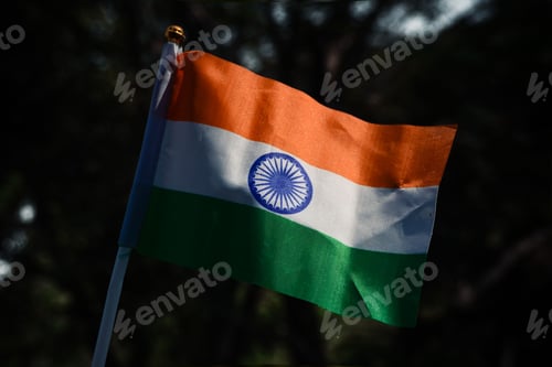 Preview: Vibrant Indian flag blowing in the breeze on a bright and sunny day.