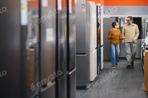 Preview: Adult couple shopping for new refrigerator in appliance store