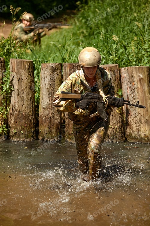 Preview: Special forces soldier with weapon take part in military maneuver. War, army, technology and people