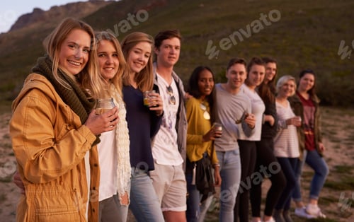 Preview: Portrait of a group of friends admiring the landscape while enjoying a drink together outside