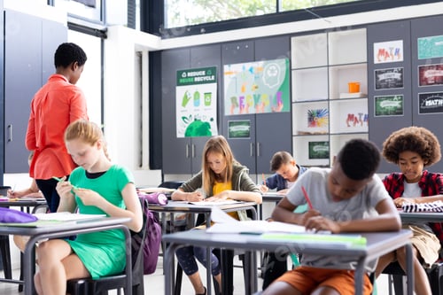 Preview: Students Learning and Writing at Desks in Classroom