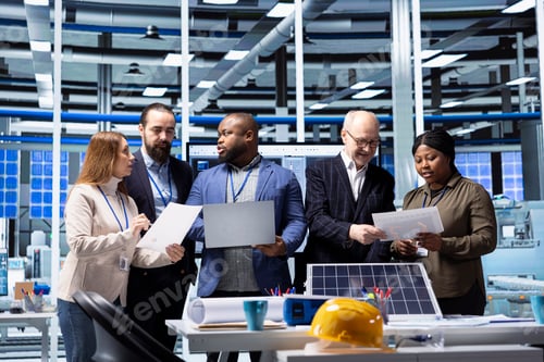 Preview: Investors and factory management executives reviewing documents