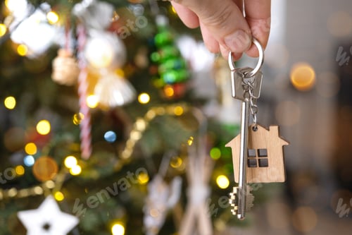 Preview: Key to the house with a keychain is hanging on the Christmas tree. A gift for New Year, Christmas. B