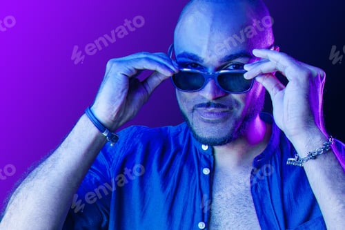 Preview: Portrait of afro american man model in glasses in neon light