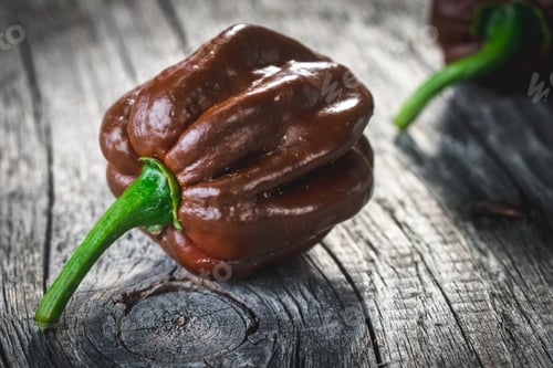 Preview: Brown Peppers On Old Wooden Background