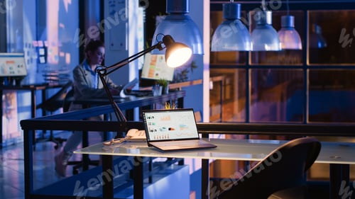 Preview: Young adult typing financial strategy data on laptop