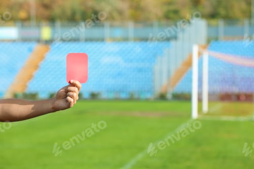 Preview: Football referee showing red card at stadium, closeup with space for text