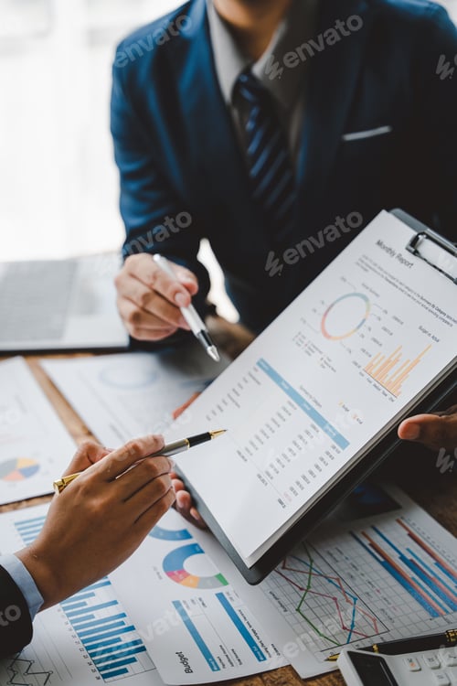 Preview: Business Professionals Discussing Monthly Reports in the Workplace