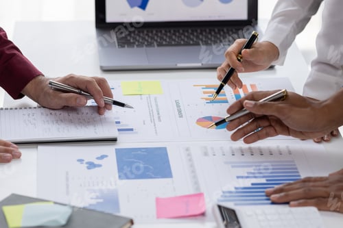 Preview: Group of confident business people point to graphs and charts to analyze market data, balance sheet,