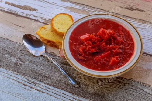 Preview: Borsch - traditional Ukrainian soup with red beets in ceramic bowl on wooden background