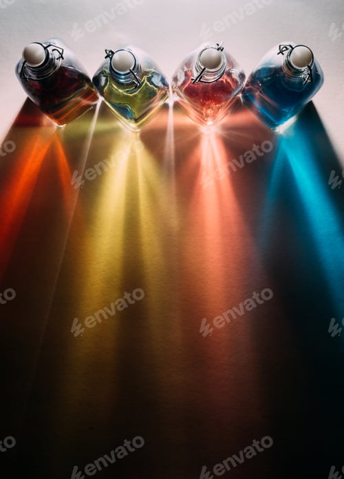 Preview: Top view shot of colorful glass bottles with flip top caps casting beautiful shadows on tabletop