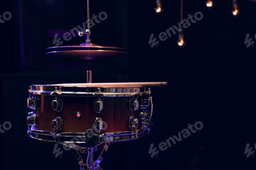 Preview: Snare drum on dark blurred background close up.