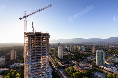 Preview: Aerial view of a residential building construction site during a vibrant summer sunset