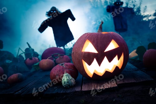 Preview: Glowing pumpkin on dark field with scarecrows for Halloween