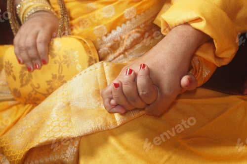 Preview: Couple holds hands in traditional attire at cultural event