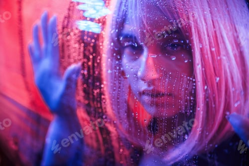 Preview: Front view. Stylish woman with white hair is behind wet transparent plastic sheet