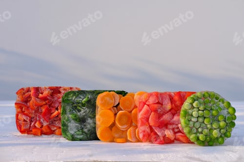 Preview: Frozen vegetables on a wooden table . side view.
