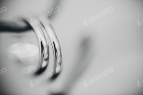 Preview: Stylish silver wedding rings on simple wooden branch, macro blurred image