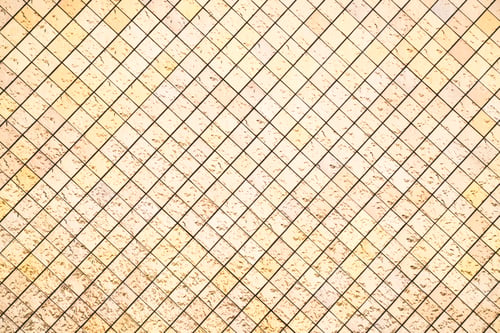 Preview: Close up of a gold mosaic tile wall with reflective surfaces.