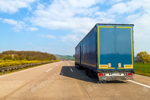 Preview: Blue cargo truck on an empty freeway