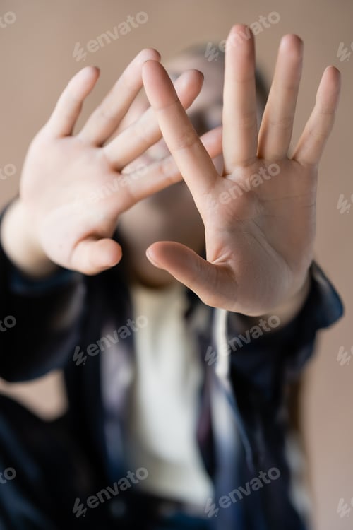 Preview: close up view of outstretched hands of blurred woman isolated on beige
