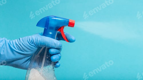 Preview: Hand in protective glove spraying disinfectant