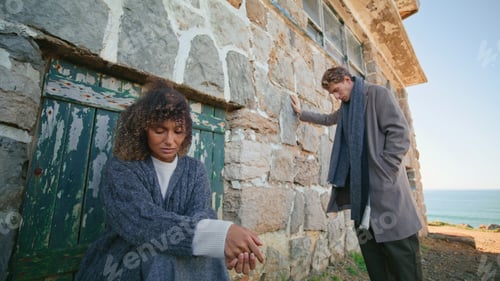 Preview: Sad man woman contemplating at beachside zoom out. Upset two people at castle