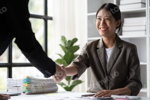 Preview: Close up view of business people shaking hands together after the deal was successful.