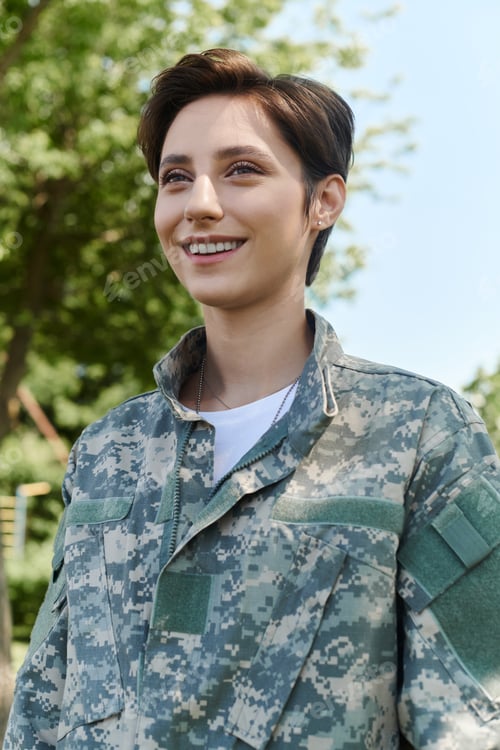 Preview: Returning home: young soldier in camouflage uniform enjoys sunny outdoor reunion