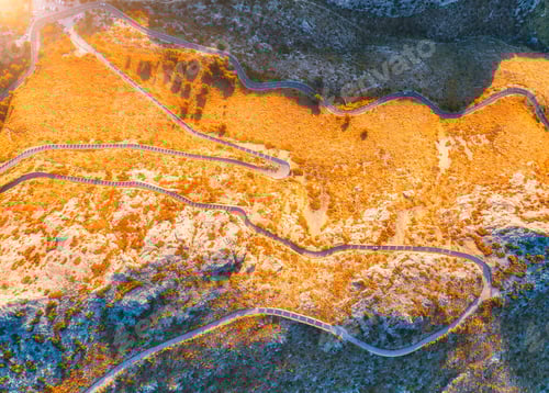 Preview: Aerial view of mountain curve road with cars, autumn forest