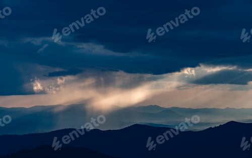 Preview: The rainy clouds above the beautiful mountain landscape.