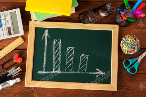 Preview: Chalkboard shows bar graph with supplies nearby on wooden table
